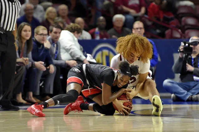 Georgia's Maya Caldwell, left, and South Carolina's Brea Beal battle for a loose ball during a quarterfinal match at the Southeastern women's NCAA college basketball tournament in Greenville, S.C., Friday, March 6, 2020. (Photo by Richard Shiro/AP Photo)