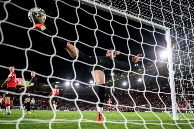 Stoke City's Irish striker #09 Thomas Cannon stretches as he attempts to stop the ball shot by Southampton's English defender #06 Taylor Harwood-Bellis to get in the goal during the English League Cup round of 16 football match  between Southampton and Stoke City at St Mary's Stadium in Southampton, southern England, on October 29, 2024. (Photo by Adrian Dennis/AFP Photo)