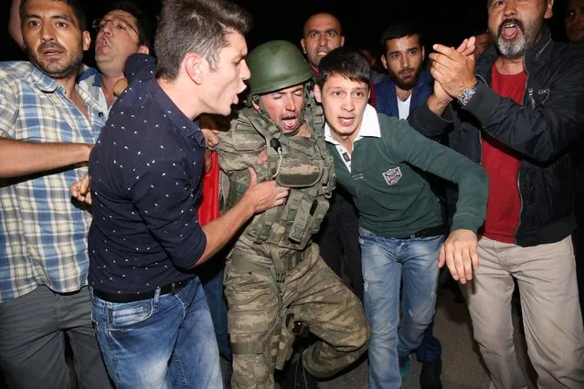 A group of soldiers, attended Parallel State/Gulenist Terrorist Organization's coup attempt, are being neutralized after they tried to storm into state run Turkish Radio and Television Corporation (TRT) in Ankara, Turkey on July 16, 2016 while people are reacting against military coup attempt. Parallel state is an illegal organization backed by U.S.-based preacher Fethullah Gulen. (Photo by Cem Ozdel/Anadolu Agency/Getty Images)
