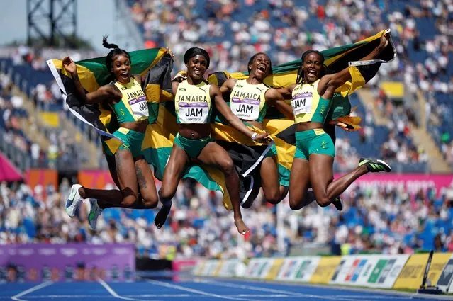 Jamaica's Elaine Thompson-Herah, Remona Burchell, Kemba Nelson and Natalliah Whyte celebrate after winning bronze in the women's 4 x 100m relay final event at the Alexander Stadium, Birmingham, England, during the Commonwealth Games on August 7, 2022. (Photo by John Sibley/Reuters)