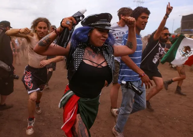 Festivalgoers celebrate during the Wacken Open Air 2022 heavy metal festival in Wacken, Germany on August 4, 2022. (Photo by Thilo Schmuelgen/Reuters)