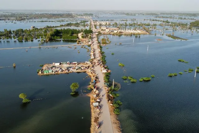 This aerial photograph shows makeshift tents for people displaced due to the floods after heavy monsoon rains at Sohbatpur in Jaffarabad district of Balochistan province on September 4, 2022. (Photo by Fida Hussain/AFP Photo)