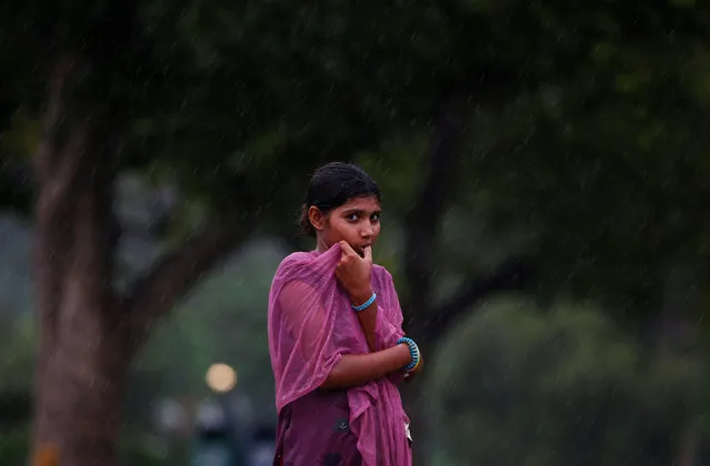 A girl is seen as it rains in New Delhi, India August 1, 2016. (Photo by Adnan Abidi/Reuters)