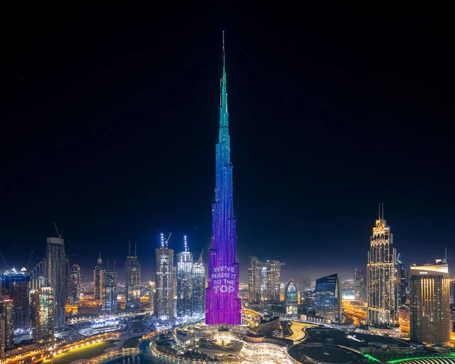 A handout image made available by the Mohammed Bin Rashid Al Maktoum Global Initiatives (MBRGI) on May 12, 2020, shows Burj Khalifa during a light show to mark “10 million meals” Covid-19 campaign. One pixel at a time, Dubai will light up the facade of the world's tallest building to represent each donation made to relieve coronavirus-hit communities across the United Arab Emirates. The Burj Khalifa, which stands 828 metres (2,717 feet) high, was transformed into the “world's tallest donation box” as part of a campaign to provide 10 million meals to low-income people. (Photo by Mohammed Bin Rashid Al Maktoum Global Initiatives/AFP Photo)