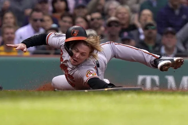 Baltimore Orioles' Kyle Stowers slides safe at home after Orioles' Adley Rutschman grounded out in the third inning of a baseball game against the Boston Red Sox, Thursday, September 29, 2022, in Boston. (Photo by Steven Senne/AP Photo)