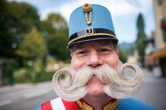 A participant wearing an historical imperial uniform takes part in a parade to celebrate the reception of the imperial couple during the Imperial Days in Bad Ischl, Austria, 15 August 2016. Hundreds of spectators celebrate the Imperial Party in honor of Empress Elisabeth “Sisi” and Emperor Franz Joseph I of Austria, impersonated by actors. The centenary of Franz Joseph's death will be on 21 November 2016. (Photo by Christian Bruna/EPA)