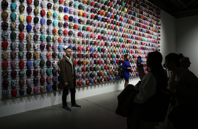 Visitors pose for pictures in front of the “A Person Is Not A Bird That Flies Away” art installation during Ahmet Gunestekin's 'The Lost Alphabet' exhibition at the Feshane in Istanbul, Turkey, 29 January 2025. The exhibition runs from 17 January to 20 July 2025. (Photo by Erdem Sahin/EPA/EFE)