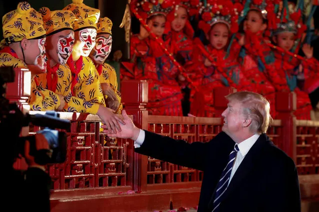U.S. President Donald Trump shakes hands with opera performers at the Forbidden City in Beijing, China, November 8, 2017. (Photo by Jonathan Ernst/Reuters)