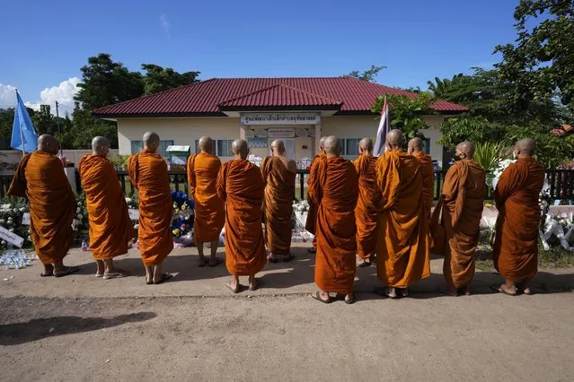 Buddhist monks pray for the victims of a mass killing attack in front on the Young Children's Development Center in Uthai Sawan, north eastern Thailand, Sunday, October 9, 2022. A former police officer burst into a day care center in northeastern Thailand on Thursday, killing dozens of preschoolers and teachers before shooting more people as he fled. (Sakchai Lalit/AP Photo)