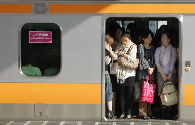 Women board a “women only” passenger train during morning rush hours in Tokyo October 7, 2011. East Japan Railway company, along with other railway companies, introduced the women only carriages in 2002 as part of efforts to tackle the problem of men who take advantage of overcrowding to grope female passengers. (Photo by Yuriko Nakao/Reuters)