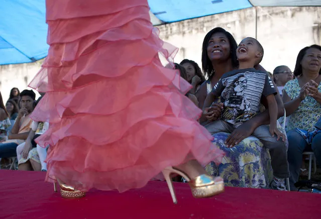 Inmates and their relatives watch female prisoners compete in an annual beauty contest at Talavera Bruce penitentiary in Rio de Janeiro, Brazil, early Thursday, November 23, 2017. After having their hair and makeup done, 10 inmates were judged on their beauty, appeal and attitude as the prison’s other inmates and relatives applauded. (Photo by Silvia Izquierdo/AP Photo)