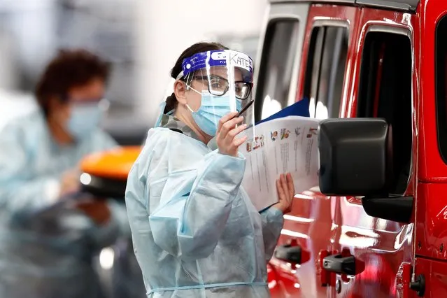 A member of the ADF (Australian Defence Force) administers a COVID-19 test at Melbourne Showgrounds on June 29, 2020 in Melbourne, Australia. Victoria has recorded 75 new coronavirus cases overnight, the state's fourth-highest single day rise since the start of the pandemic, while increased testing in Melbourne suburbs that have been identified as community transmission hotspots for coronavirus continues. Restrictions in Victoria have been tightened in response to the spike in new cases across the state with premier Daniel Andrews extending the current state of emergency for at least four weeks to allow police the power to enforce social distancing rules. (Photo by Darrian Traynor/Getty Images)