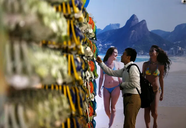 A man looks at products during the opening of the Rio 2016 Olympics megastore on Copacabana beach in Rio de Janeiro, Brazil, June 30, 2016. (Photo by Pilar Olivares/Reuters)