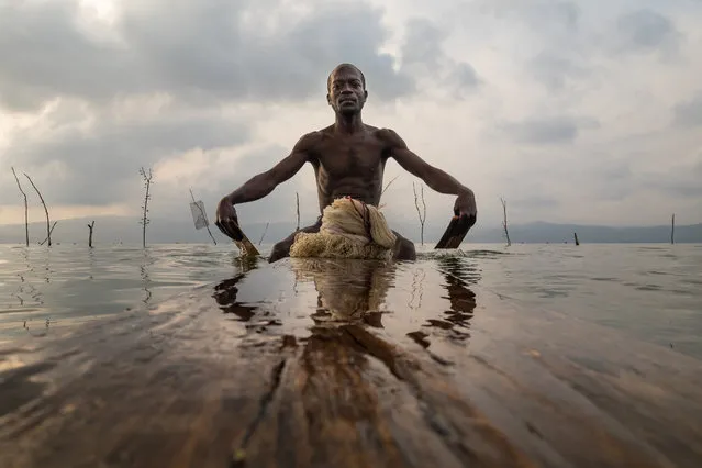 This 1 million-year-old lake was created when a giant meteorite crash-landed in what was once a lush rainforest. In the Ghana's Ashanti region, lake Bosumtwi is revered as sacred and tradition dictates that locals can only fish there using wooden planks called paduas. (Photo by Joel Santos/Barcroft Images)