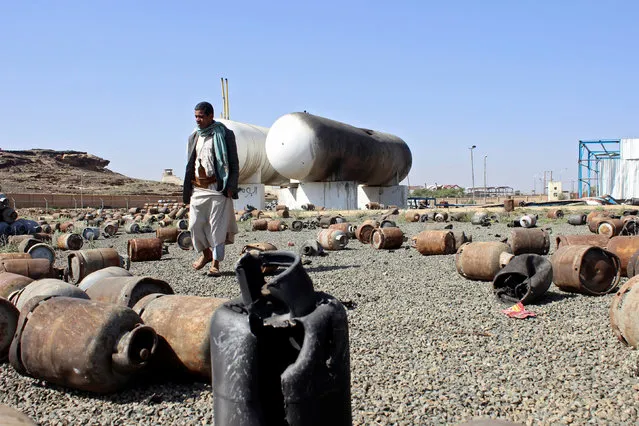 A man walks past cooking gas cylinders in the yard of a gas station after it was hit by a Saudi-led air strike in the northwestern city of Saada, Yemen August 27, 2016. (Photo by Naif Rahma/Reuters)