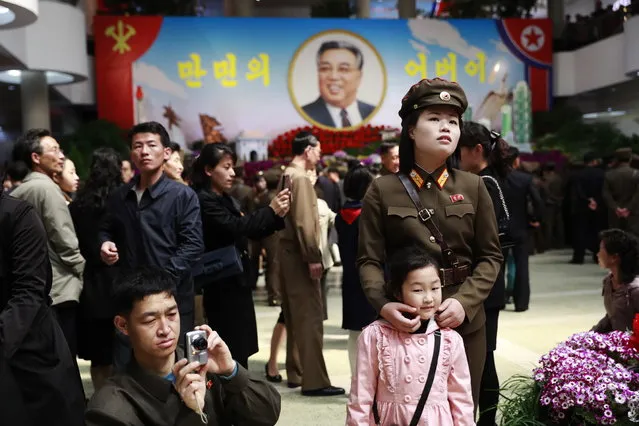 A North Korean female soldier and her child attend a flower exhibition as part of celebrations to mark the “Day of the Sun” commemorating the 105th birth anniversary of late supreme leader Kim Il-sung in Pyongyang, North Korea, 16 April 2017. (Photo by How Hwee Young/EPA/EFE)