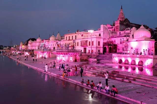 Temples and other buildings on the bank of Sarayu river are seen illuminated ahead of the foundation-laying ceremony for a Hindu temple in Ayodhya, India, August 4, 2020. (Photo by Pawan Kumar/Reuters)