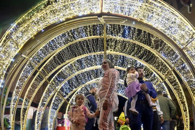 Visitors view seasonal illuminations to celebrate the upcoming Christmas and the New Year holidays at Beirut Souks in downtown Beirut, Lebanon, 04 December 2022. (Photo by Wael Hamzeh/EPA/EFE)