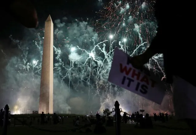 Protesters watch from Constitution Avenue as Trump campaign fireworks explode behind the Washington Monument in Washington, U.S. August 27, 2020. (Photo by Leah Millis/Reuters)
