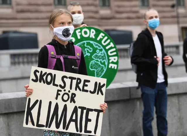 Swedish climate activist Greta Thunberg holds a poster reading “School strike for Climate” as she protests in front of the Swedish Parliament Riksdagen on Friday, September 4, 2020. (Photo by Fredrik Sandberg/TT News Agency/AFP Photo)