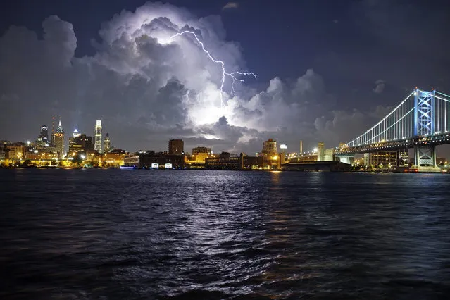 Lightning illuminates storm clouds over the Philadelphia skyline, Tuesday August 16, 2016, seen from across the Delaware River in Camden NJ. (Photo by Joseph Kaczmarek/AP Photo)