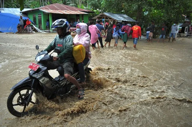A motorbike rider breaks through the flash floods that block the main road, in Rogo Village, Dolo Selatan District, Sigi Regency, Indonesia on September 15, 2020. (Photo by Faldi Muhammad/NurPhoto via Getty Images)