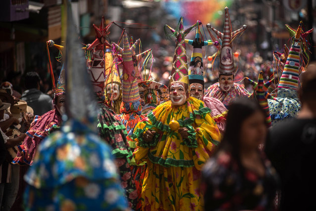 Groups of traditional dancers perform through the streets of the town as part of the “Santa Maria Magdalena Patron Feast” on July 20, 2025 in Xico, Veracruz, Mexico. Thousands of people visit Xico to celebrate the town's patron saint, Santa Maria Magdalena. The event offers many cultural and religious activities, as the streets are decorated with sawdust carpets, many groups perform dances, and people gather to take part in different processions. (Photo by Hector Quintanar/Getty Images)