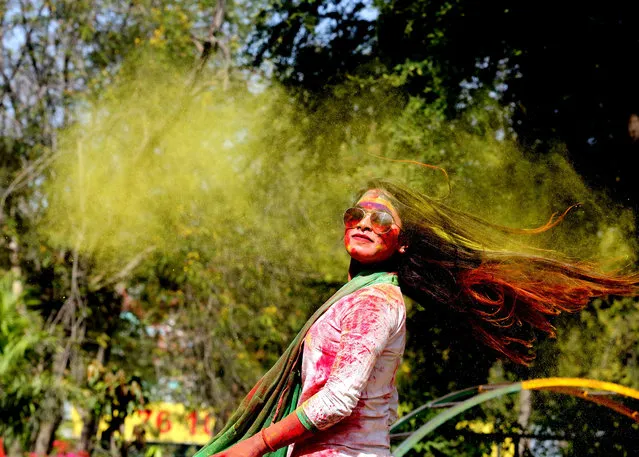 Indian college girls take part in the Holi festival celebrations in Bhopal, India, 28 Feburary 2018. Holi is celebrated on the full moon day and marks the beginning of the spring season. (Photo by Sanjeev Gupta/EPA/EFE)