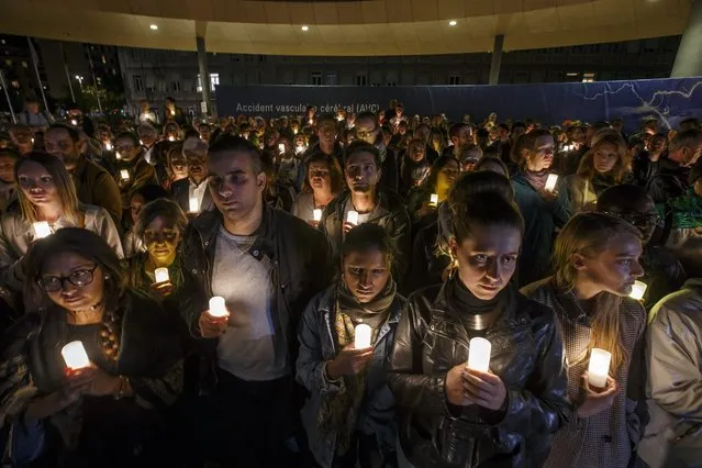 Participants and staff MSF (Medecins Sans Frontieres) hold lights during a commemoration for the victims of the US attack on the Kunduz hospital in Afghanistan, at the Geneva University Hospital (HUG) in Geneva, Switzerland, 03 October 2016. The Medecins Sans Frontieres, MSF, also known as Doctors Without Borders, launches the #NotATarget campaign so to increase the political costs of non-compliance of the laws of war and inform civil society of the non-compliance of unarmed populations in conflict zones. (Photo by Salvatore Di Nolfi/EPA)