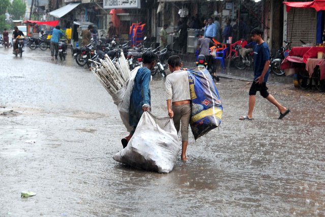 People make their way after heavy downpour in Hyderabad, Pakistan, 27 June 2025. (Photo by Nadeem Khawar/EPA)
