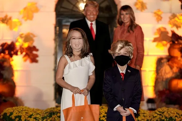 Children dressed as U.S. President Donald Trump and U.S. first lady Melania Trump attend a Halloween event hosted by President Trump and the first lady at the White House in Washington, U.S.,October 25, 2020. (Photo by Ken Cedeno/Reuters)