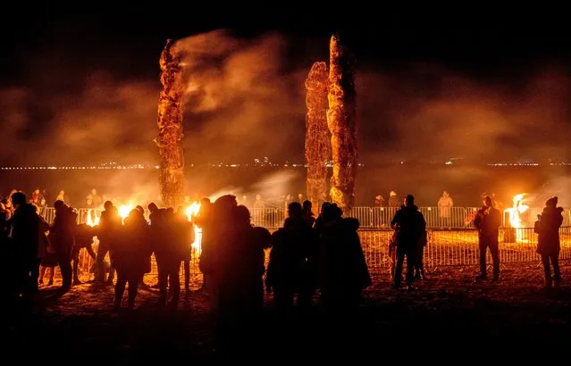 People watch bonfires at the beach of the Baltic Sea in Niendorf, northern Germany, Saturday, February 11, 2023. (Photo by Michael Probst/AP Photo)