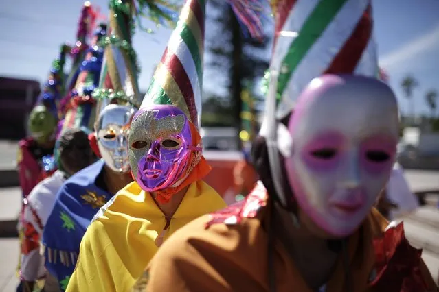 Indigenous dancers participate in a traditional healing ceremony for the mother earth at El Salvador del Mundo Square in San Salvador, December 10, 2014. Salvadorean indigenous organizations participated in a ceremony to ask for solutions to stop climate change and respect planet earth as the U.N. Climate Change Conference COP 20 is bring held in Peru. (Photo by Jose Cabezas/Reuters)