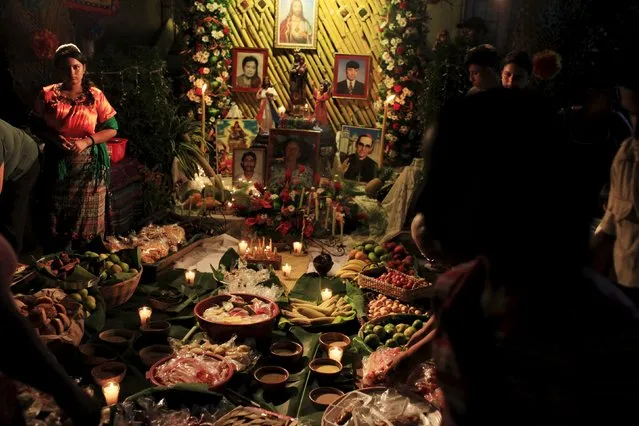 A girl stands at a family altar during the celebration of "Los Canchules" in Nahuizalco November 1, 2015. (Photo by Jose Cabezas/Reuters)