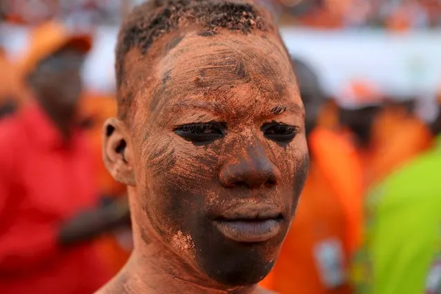 A supporter of presidential candidate Roch Marc Kabore wears orange face paint at Kabore's last campaign rally in Ouagadougou, Burkina Faso, November 27, 2015. Burkina Faso votes in its first free election in three decades this weekend, choosing a replacement for long-time leader Blaise Compaore, who was ousted a year ago in a military-backed uprising. (Photo by Joe Penney/Reuters)