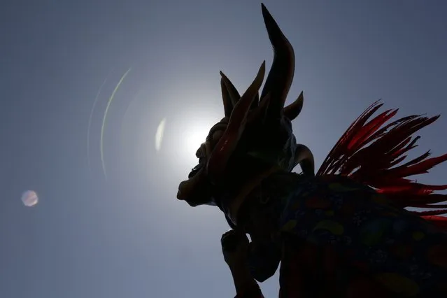 A man dressed in a traditional costume is seen during the Diablicos Sucios or Dirty Devils dance parade in Las Tablas, in the province of Los Santos January 11, 2015. (Photo by Carlos Jasso/Reuters)