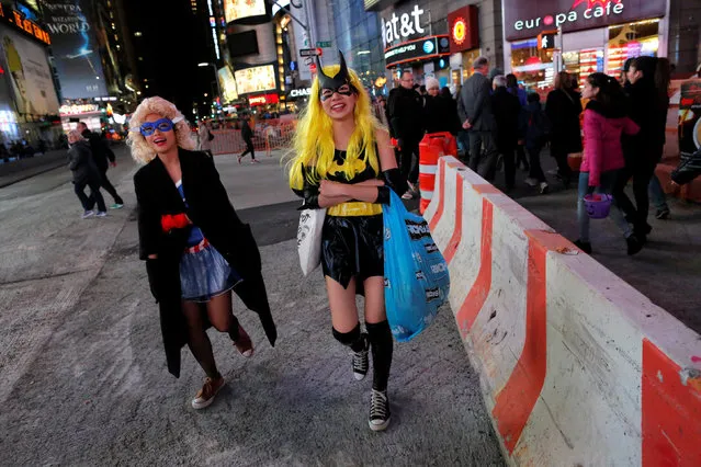 People in costume walk through Times Square on Halloween in Manhattan, New York, U.S., October 31, 2016. (Photo by Andrew Kelly/Reuters)