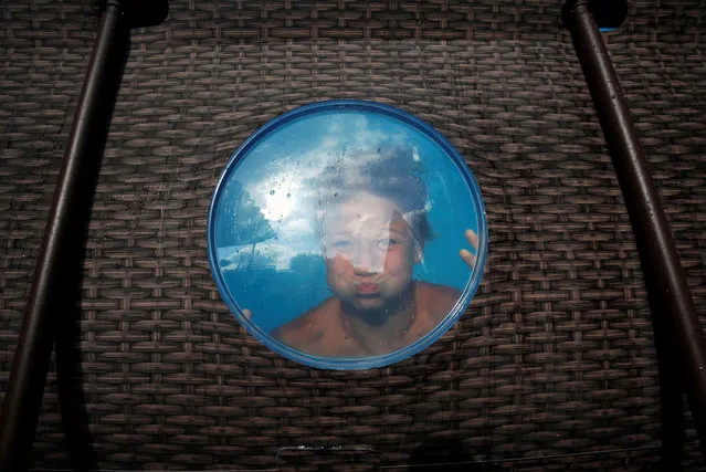 Albert Cano Lapuente reacts as he cools off in a Bestway Above Ground Pool at his home, during the coronavirus disease (COVID-19) outbreak in Premia de Mar, north of Barcelona, Spain on August 3, 2020. (Photo by Albert Gea/Reuters)