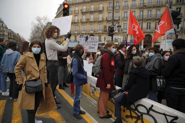 Students gather during a protest in Paris, Tuesday January 26, 2021. Schoolteachers and university students marched together in protests or went on strike Tuesday around France to demand more government support amid the pandemic. (Photo by Christophe Ena/AP Photo)