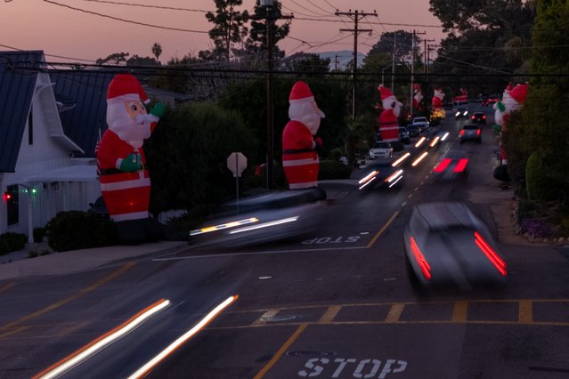 Continuing a neighborhood Christmas tradition, giant inflatable Santas stretch along a busy Highland Drive, nicknamed “HoHo Highland”, as viewed from a drone in Carlsbad, California, U.S., December 10, 2025. (Photo by Mike Blake/Reuters)