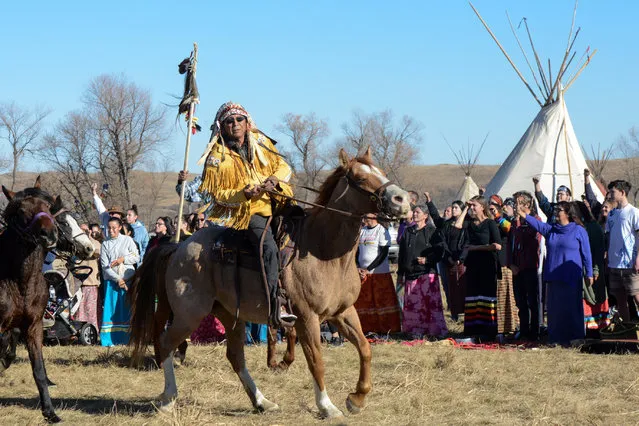 Horse riders from the Bigfoot Riders, Dakota 38 Riders, Spirit Riders and the Bigfoot Youth Riders arrive at the Oceti Sakowin camp during a protest of the Dakota Access pipeline near the Standing Rock Indian Reservation near Cannon Ball, North Dakota November 5, 2016. (Photo by Stephanie Keith/Reuters)