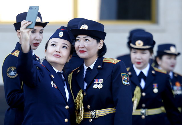 Participants take a selfie during a parade to mark the 100th anniversary of the Kyrgyz police on Ala-Too Square Bishkek, Kyrgyzstan, 01 November 2024. Kyrgyzstan commemorates the establishment of its first Kyrgyz police unit in the Kara-Kirghiz Autonomous Oblast on 01 November 1924. This day remained in history as the date of the creation of the Kyrgyz police. (Photo by Igor Kovalenko/EPA)