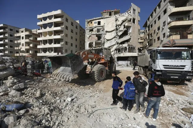 Boys inspect a site that was hit by an Israeli strike, killing a Lebanese militant leader Samir Qantar, in the Damascus district of Jaramana, Syria December 20, 2015. (Photo by Omar Sanadiki/Reuters)
