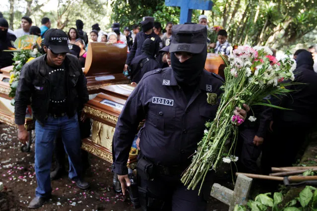 Salvadoran police officers participate in the funeral ceremony for their colleague Lorenzo Rojas Herrera and his son Marvin in Quezaltepeque, El Salvador, November 18, 2016. (Photo by Jose Cabezas/Reuters)