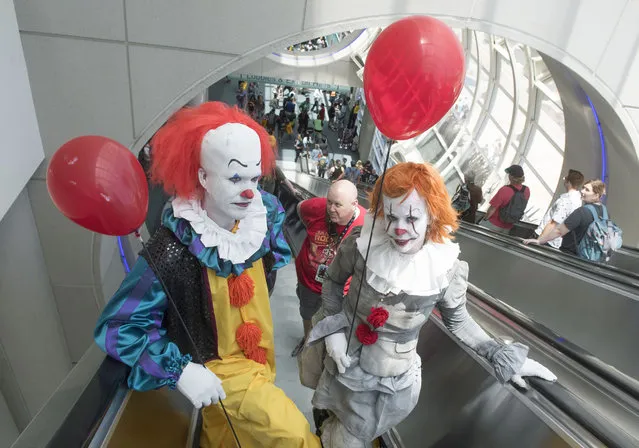 Jared and Lindsay Brzenski, of San Diego, as Pennywise the clown from It, ride the escalators during the first day of Comic-Con 2018 in San Diego on Thursday, July 19, 2018. (Photo by Kevin Sullivan/Orange County Register via Getty Images)