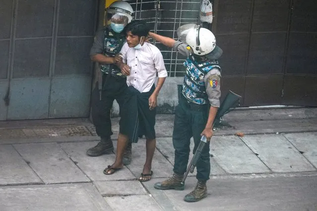 Riot police officers detain a demonstrator during a protest against the military coup in Yangon, Myanmar, March 19, 2021. (Photo by Reuters/Stringer)