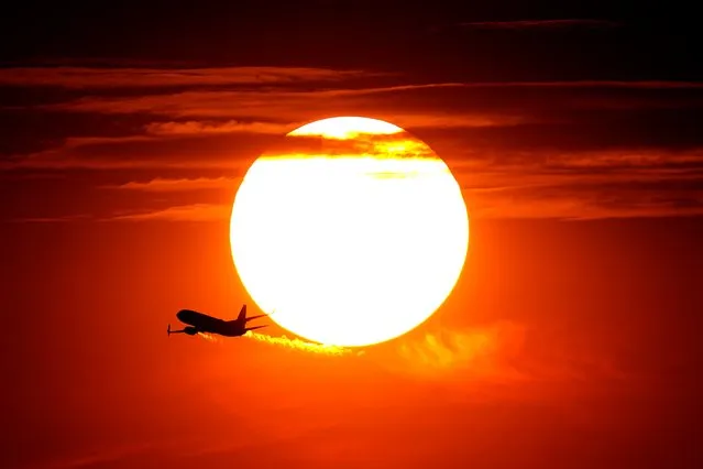 A Jet takes flight from Sky Harbor International Airport as the sun sets, Wednesday, July 12, 2023 in Phoenix. Millions of people around the Southwest are living through a historic heat wave. Even the heat-experienced desert city of Phoenix is being tested Wednesday as temperatures hit 110 degrees Fahrenheit for more than a dozen consecutive days. Phoenix is currently America's hottest large city with temperatures forecast to hit as high as 119 degrees Fahrenheit over the weekend. (Photo by Matt York/AP Photo)