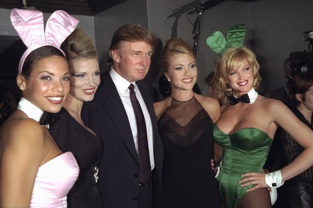 Donald Trump is flanked by Playmates at a party celebrating Playboy magazine's 45th anniversary at the Life Club in New York on December 3, 1998. (Photo by Richard Corkery/NY Daily News Archive via Getty Images)