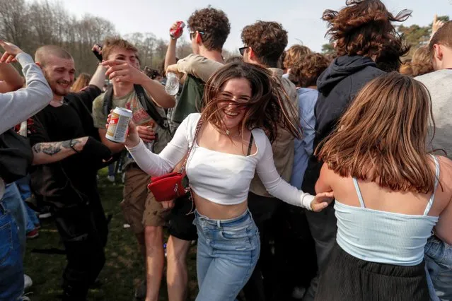 People take part in fake festival called “La Boum” organized by an anonymous group of people on Facebook for an April 1 joke at the Bois de la Cambre, in Brussels, Belgium, 01 April 2021. An anonymous group created a Facebook event called “La Boum”, touting an alleged festival to take place with famous DJs as headliners. Thousands of people on social media had shown interest to take part in the gathering, while police have advised that no authorization has been given for a music event. (Photo by Stephanie Lecocq/EPA/EFE)