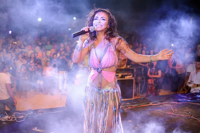 Lebanese singer Dolly Shaheen performs during a concert during he Muslim holiday of holy festival of Eid Al Adha celebrations in Alexandria, Egypt, 23 August 2018 (issued 24 August 2018). Eid al-Adha is the holiest of the two Muslims holidays celebrated each year, it marks the yearly Muslim pilgrimage (Hajj) to visit Mecca, the holiest place in Islam. Muslims slaughter a sacrificial animal and split the meat into three parts, one for the family, one for friends and relatives, and one for the poor and needy. (Photo by Mahmoud Ahmed/EPA/EFE)